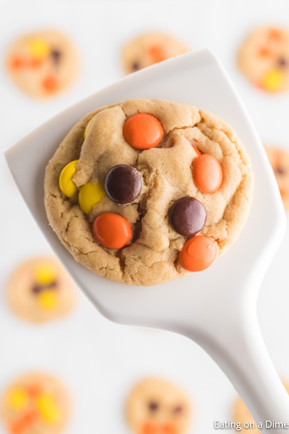 Close up image of Reese's Pieces Cookies on a spatula