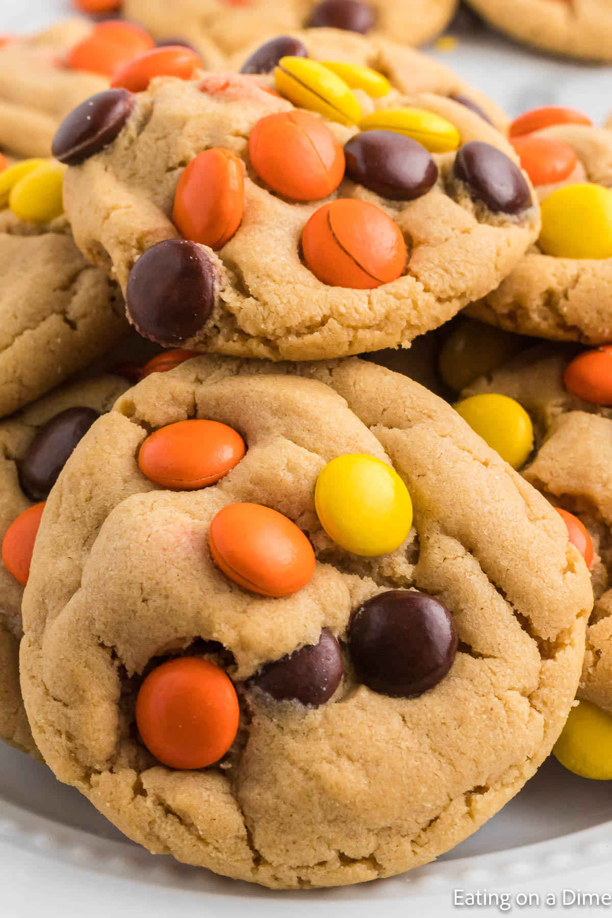 Close up image of Reese's Pieces Cookies stacked on a platter