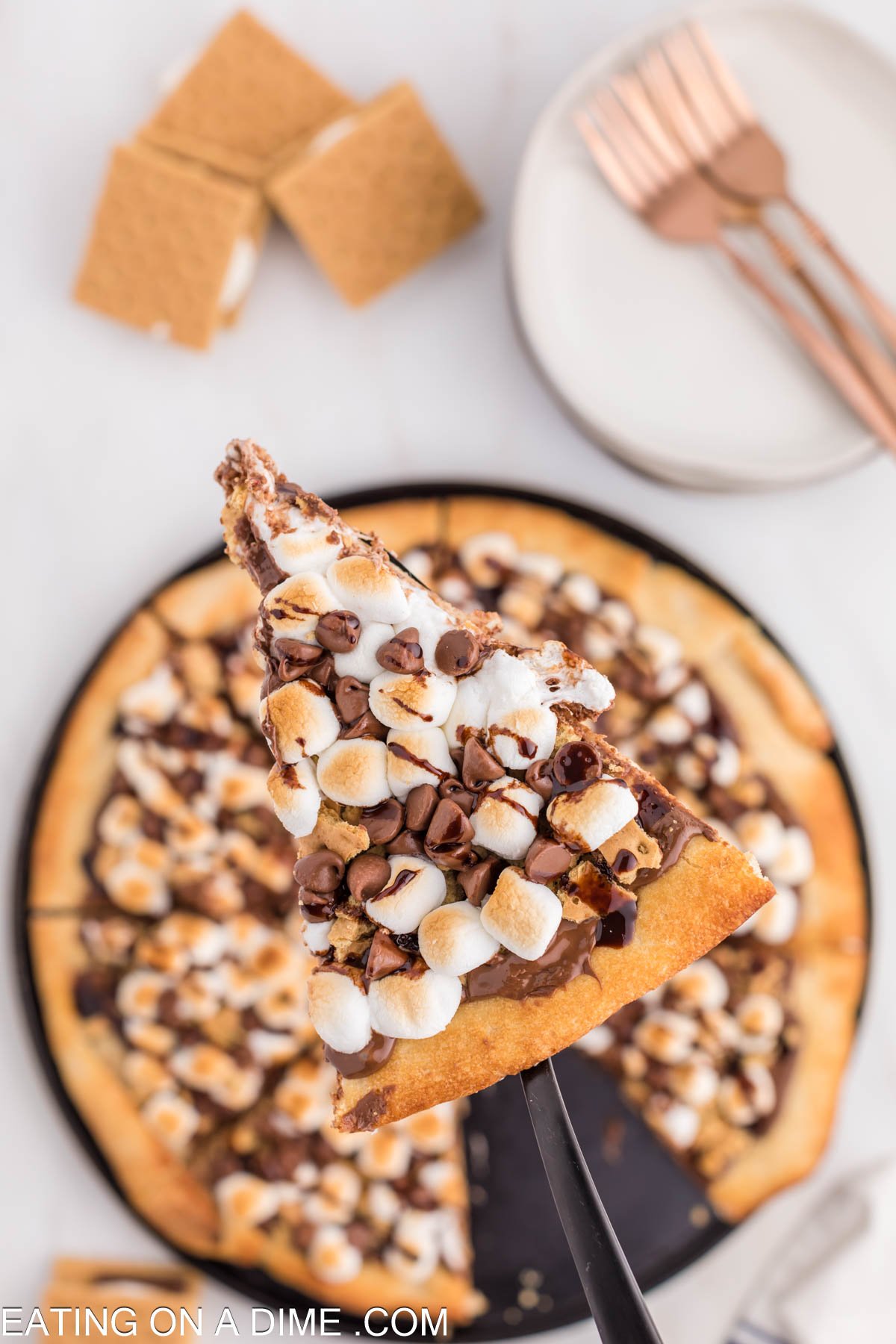Close up image of slice smores pizza on a spatula