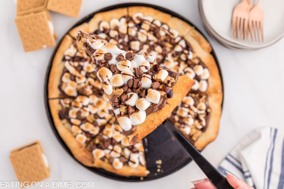 Close up image of slice of smores pizza on a spatula