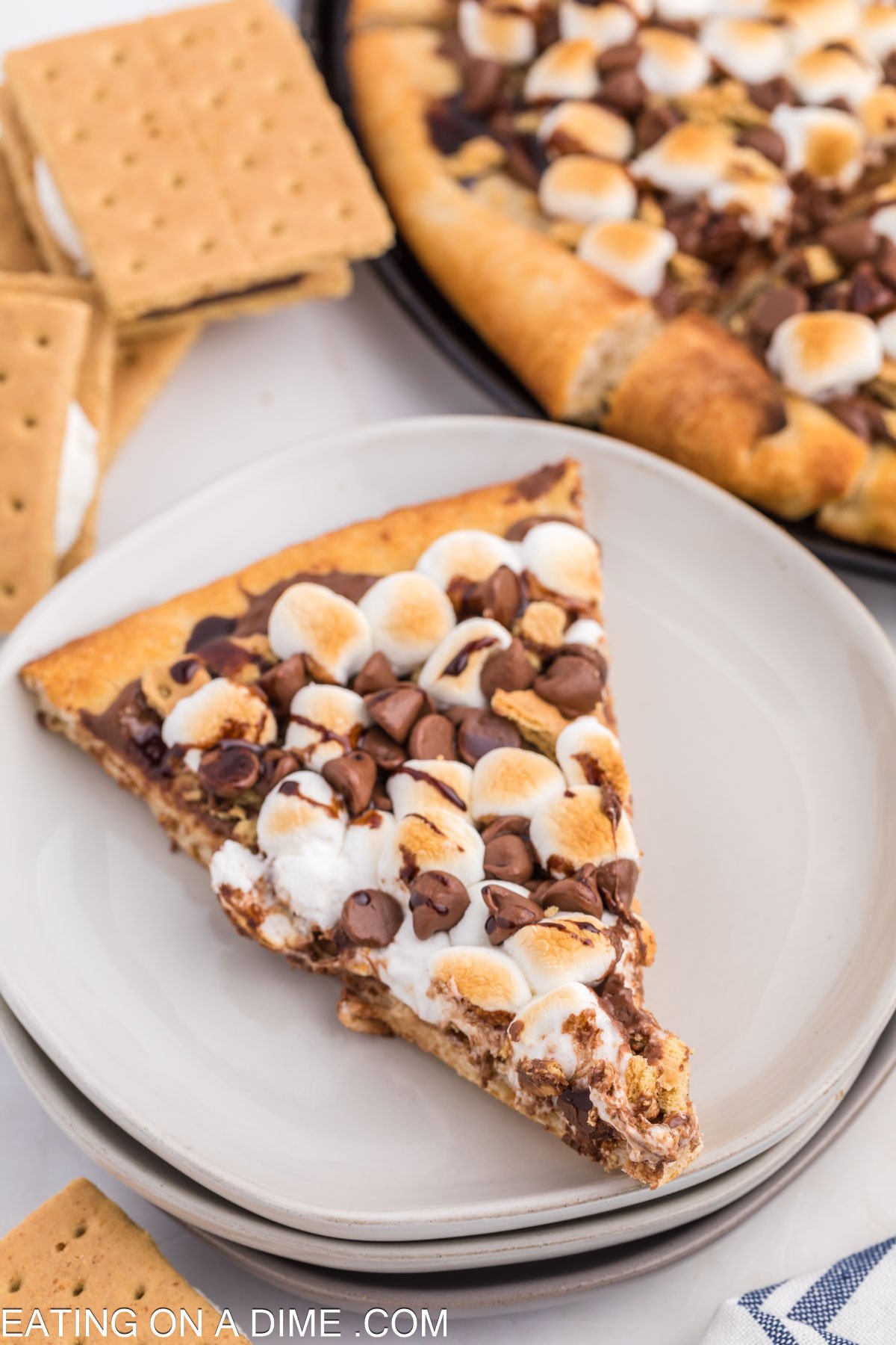 Slice of smores pizza on a white plate