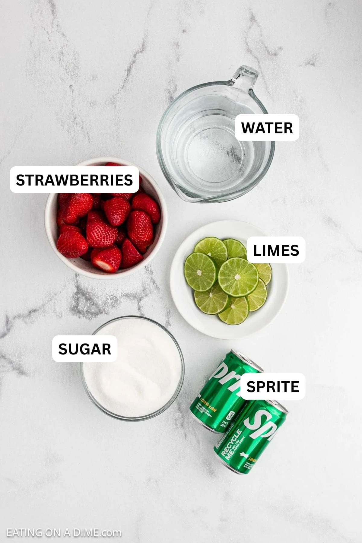 Ingredients to make this recipe which includes cans of Sprite, fresh strawberries, lime, water and sugar.