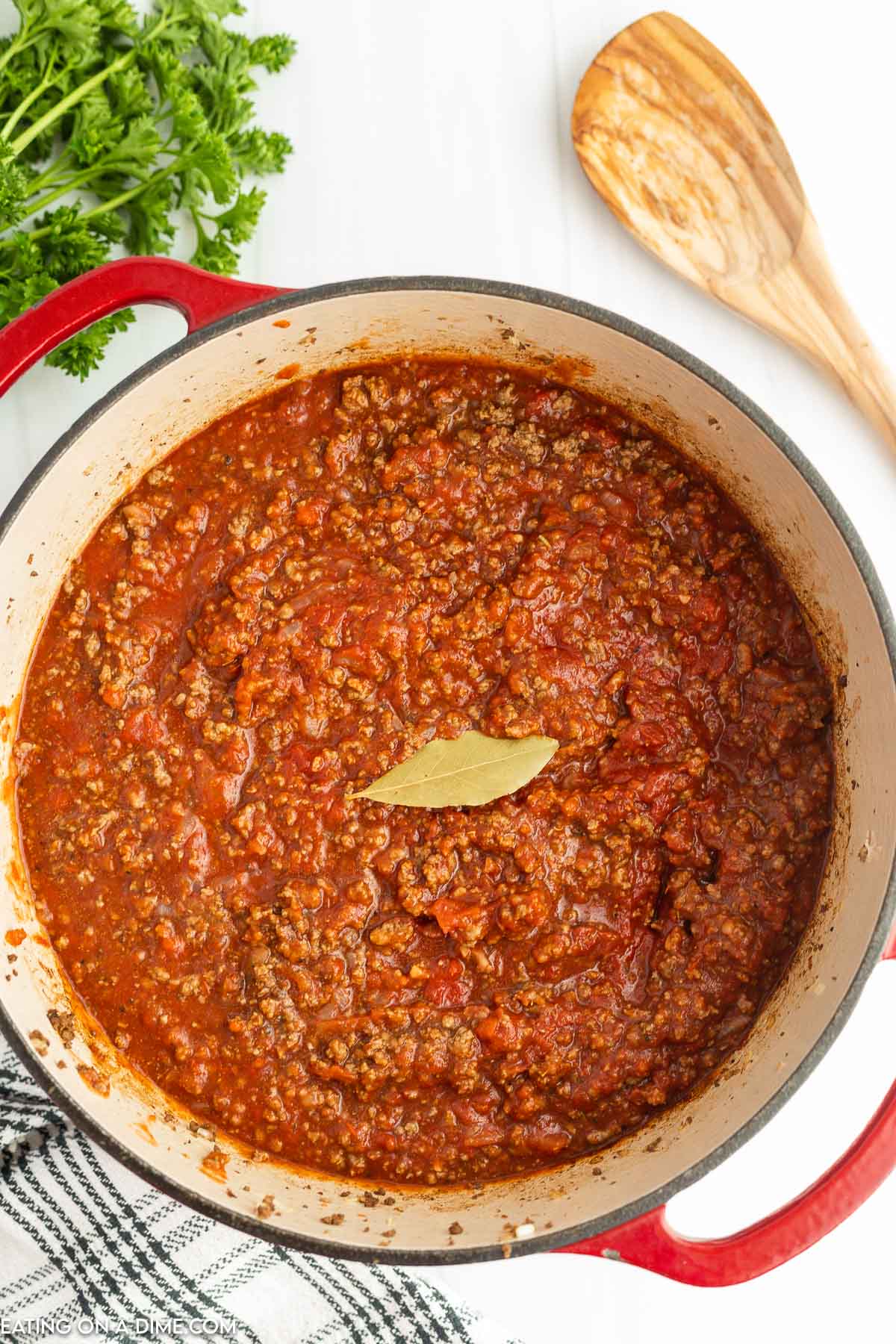 Bolognese Sauce in a Dutch Oven with a bay leaf on top