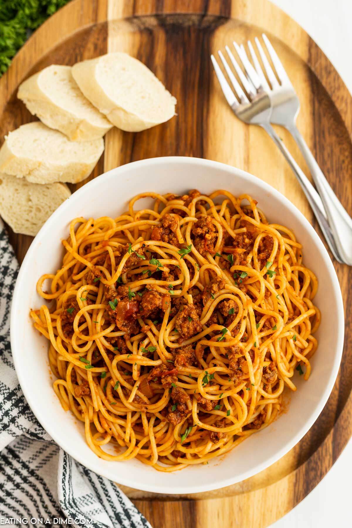 Bolognese Sauce mixed with spaghetti noodles in a white bowl