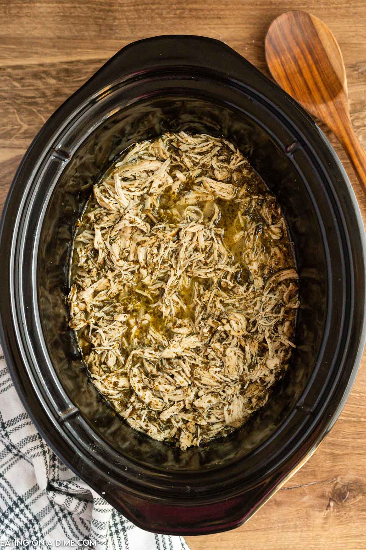 Placing the shredded chicken back in the slow cooker