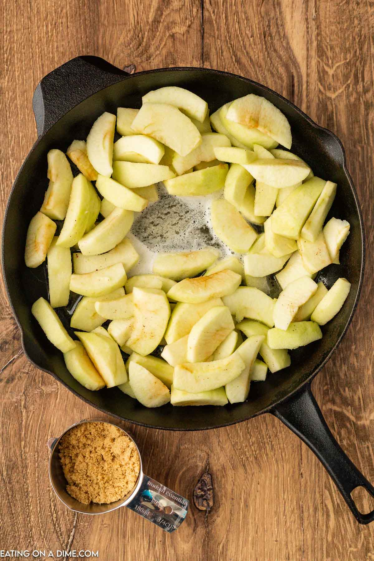 Cooking slice apples in melted butter in a cast iron skillet