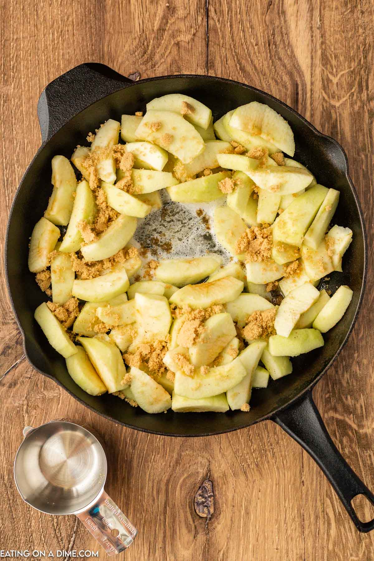 Cooking the slice apples in a cast iron skillet with brown sugar 