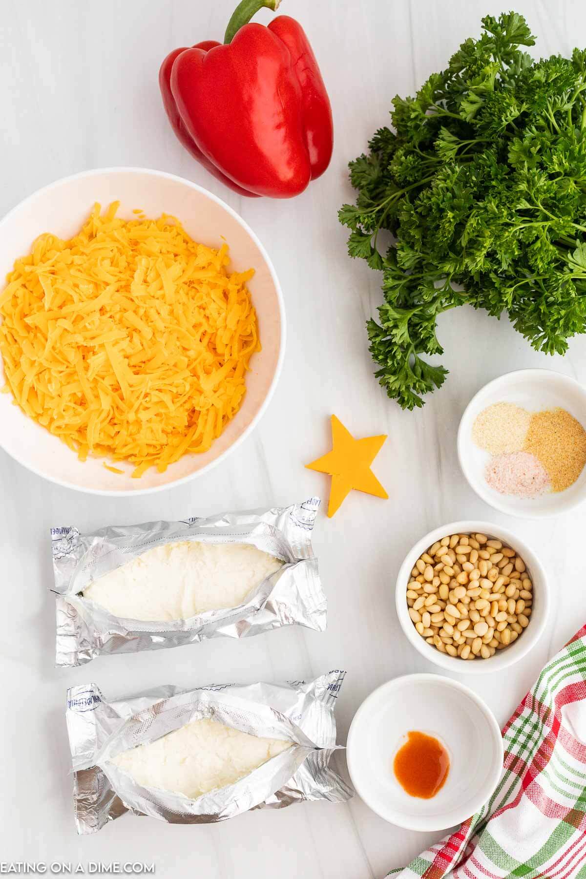 Ingredients for cheese ball- cream cheese, shredded cheese, seasonings, nuts. 
