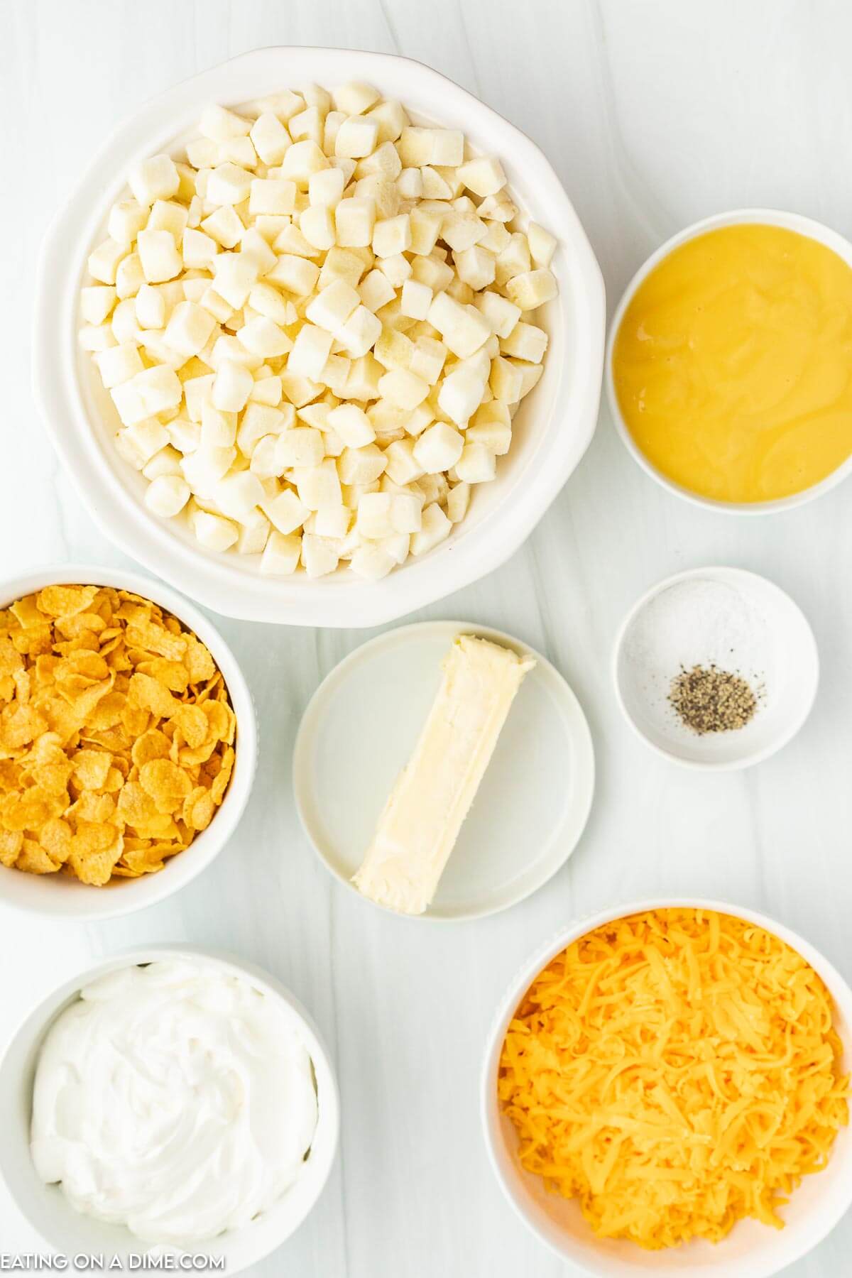 Ingredients needed - hash browns, sour cream, cream of chicken soup, butter, cheddar cheese, salt, pepper, corn flakes