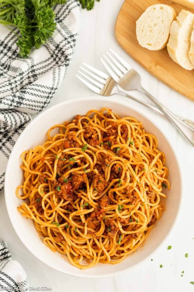 Bolognese Sauce mixed with spaghetti noodles in a white bowl