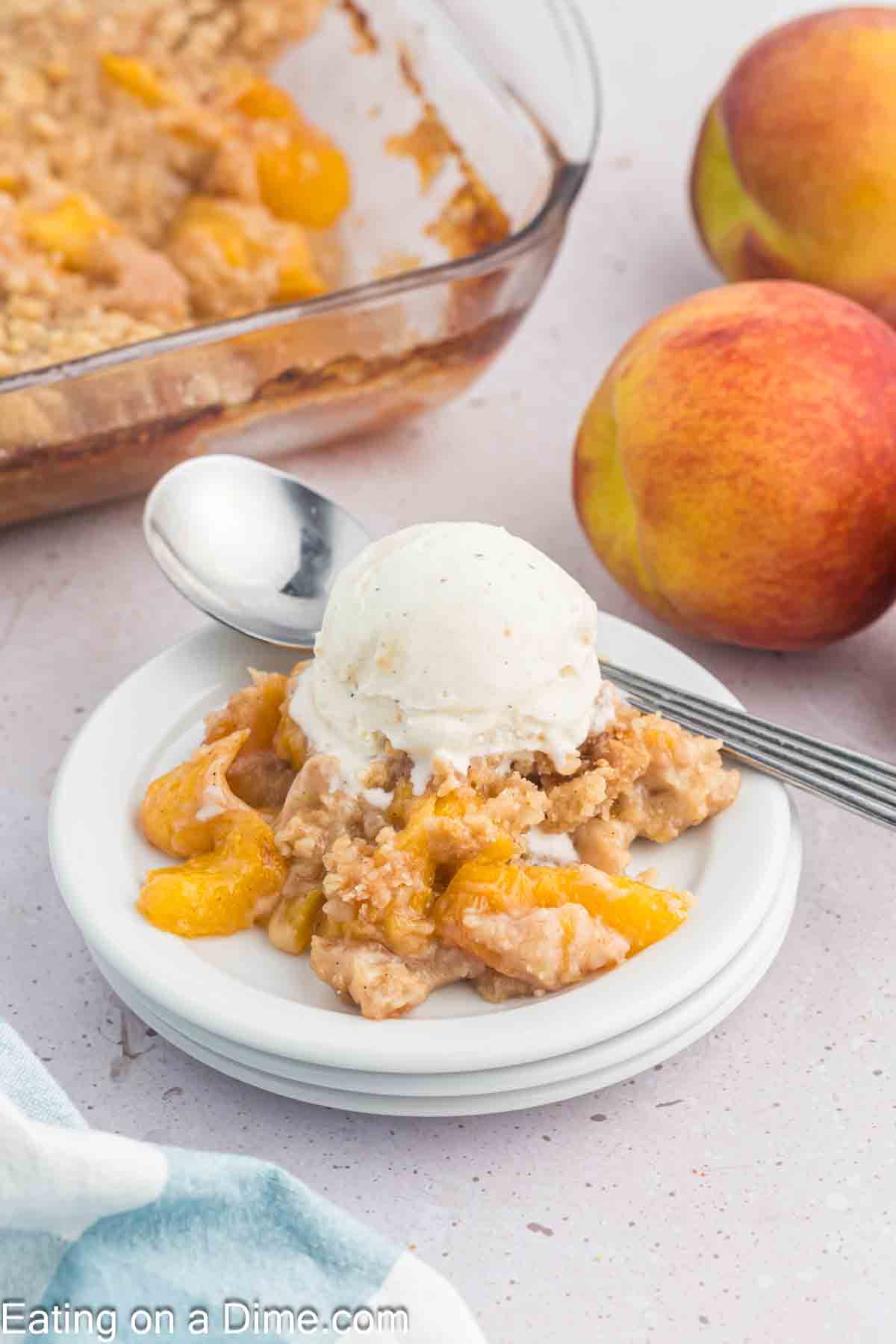 Peach crumble on a place with a scoop of ice cream