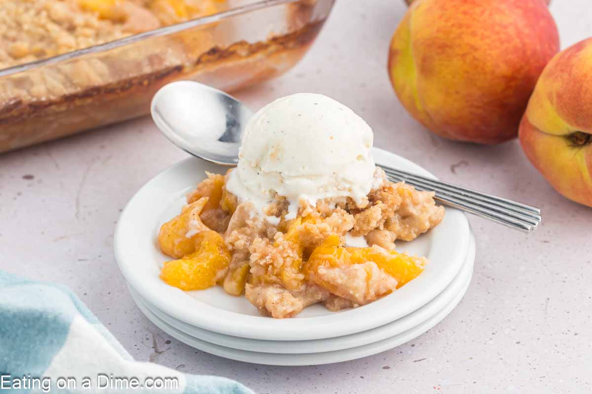 Peach crumble on a place with a scoop of ice cream