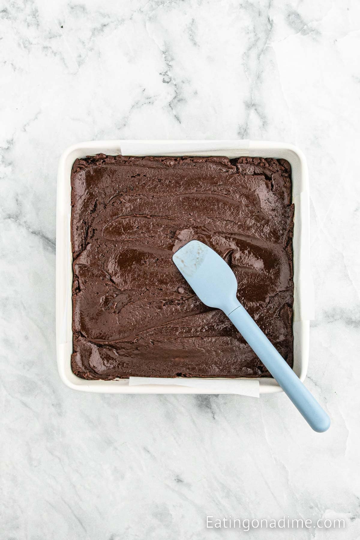 Spreading the fudge mixture into the baking dish