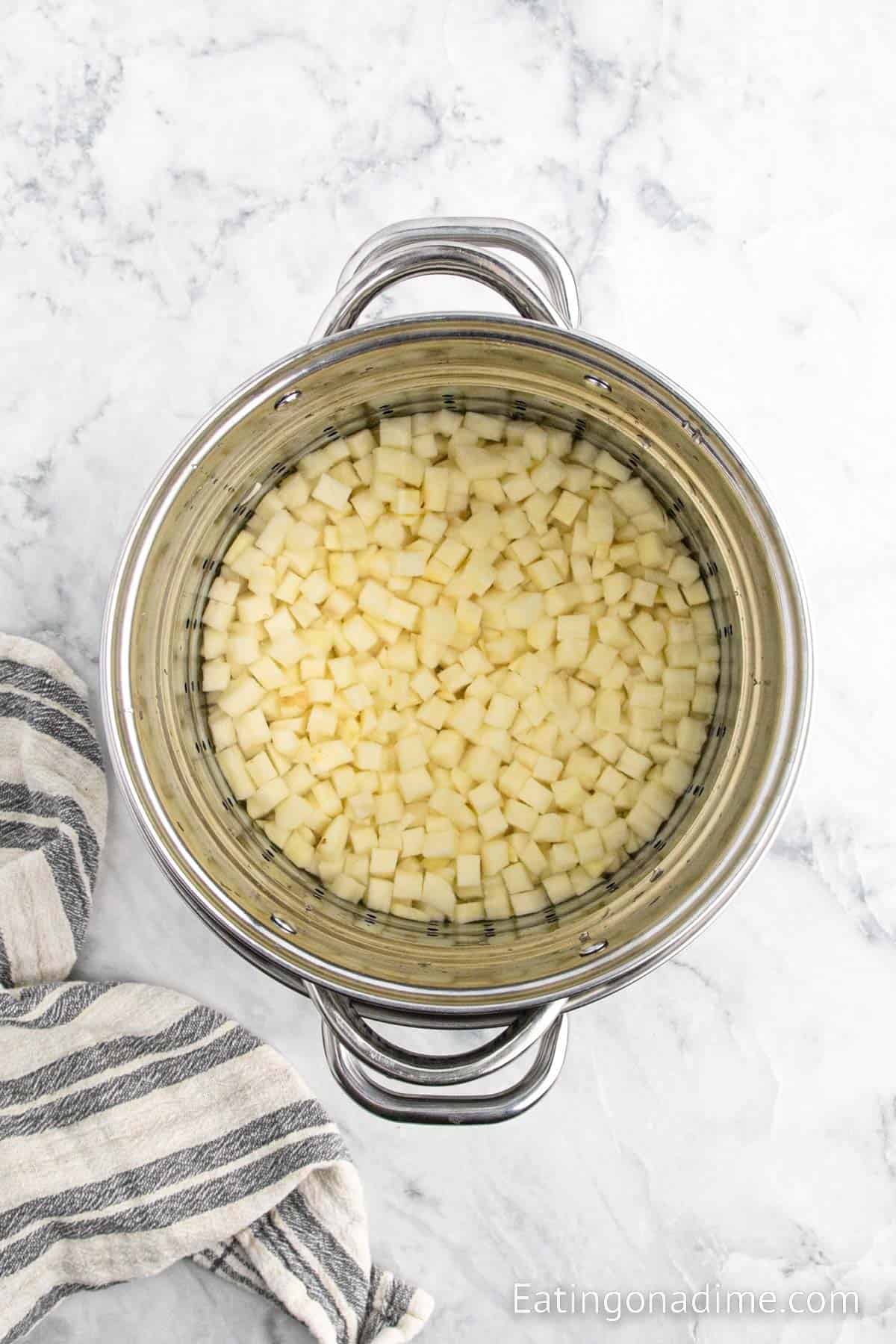 Diced potatoes in a large pot of water