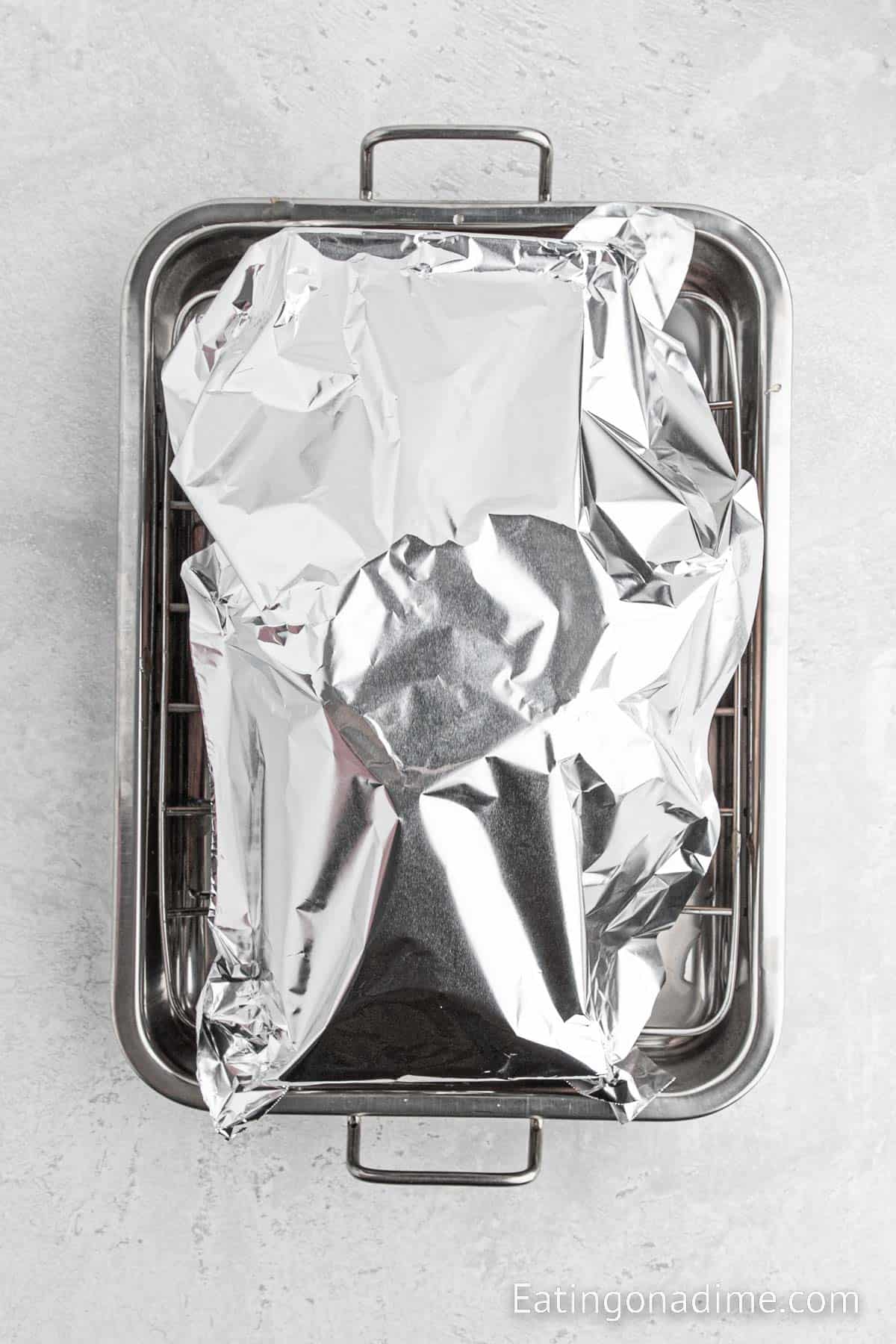 Ham covered with foil in roasting pan