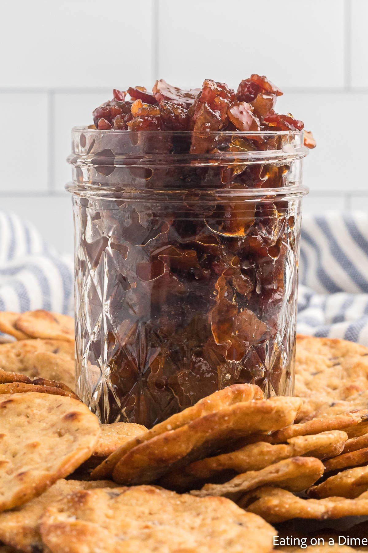 Bacon Jam in a jar with crackers on the side