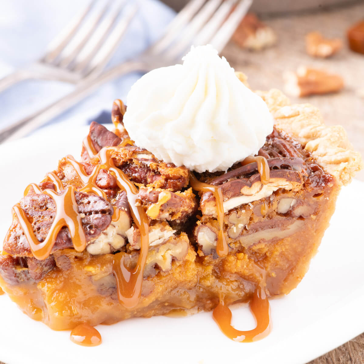 Slice of Butterscotch Pecan Pie topped with whipped cream