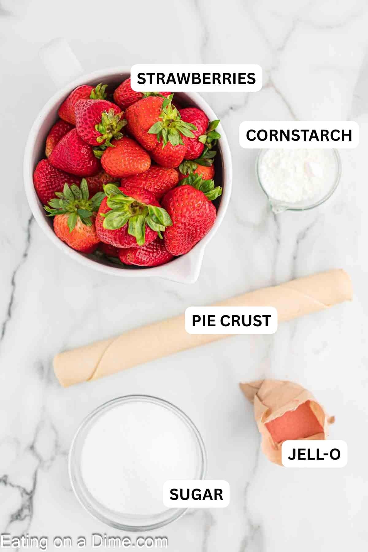 Ingredients required to make the recipe including pie crust and strawberries.
