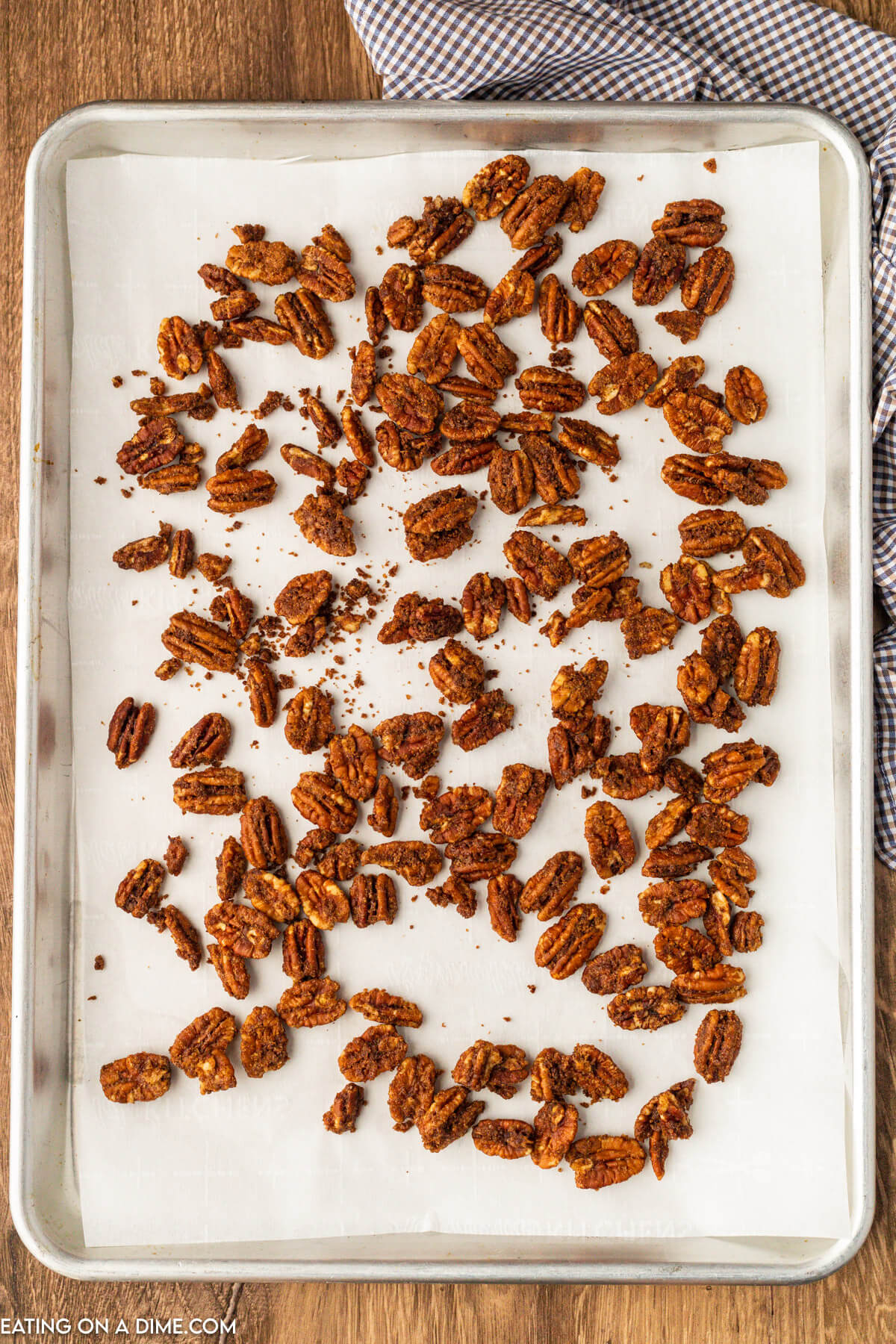 Spreading candied pecans on the baking sheet