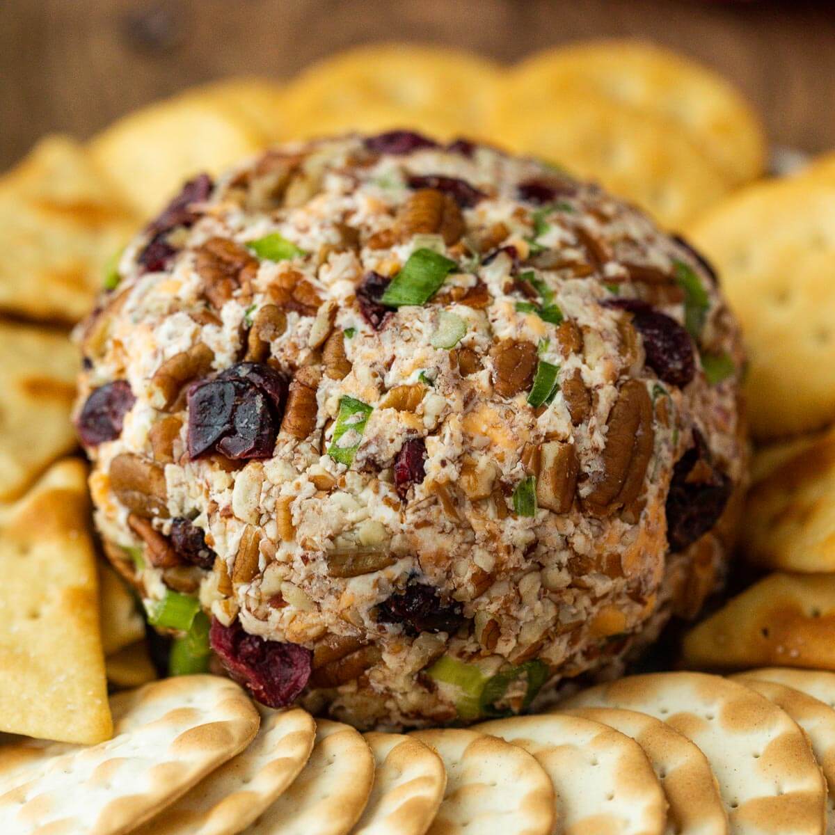Christmas Cheese Ball on a platter with a side of crackers