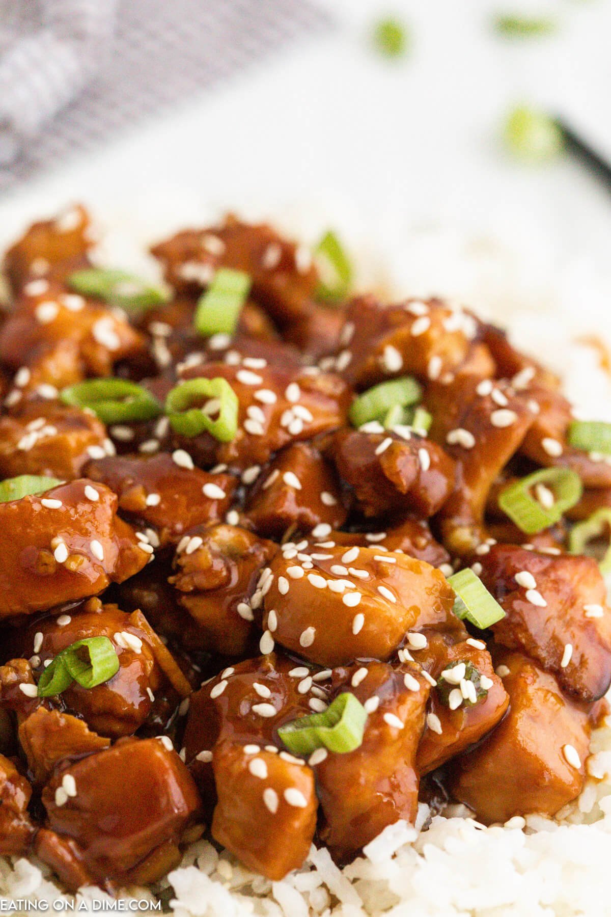 Orange Chicken on rice and served with chopsticks