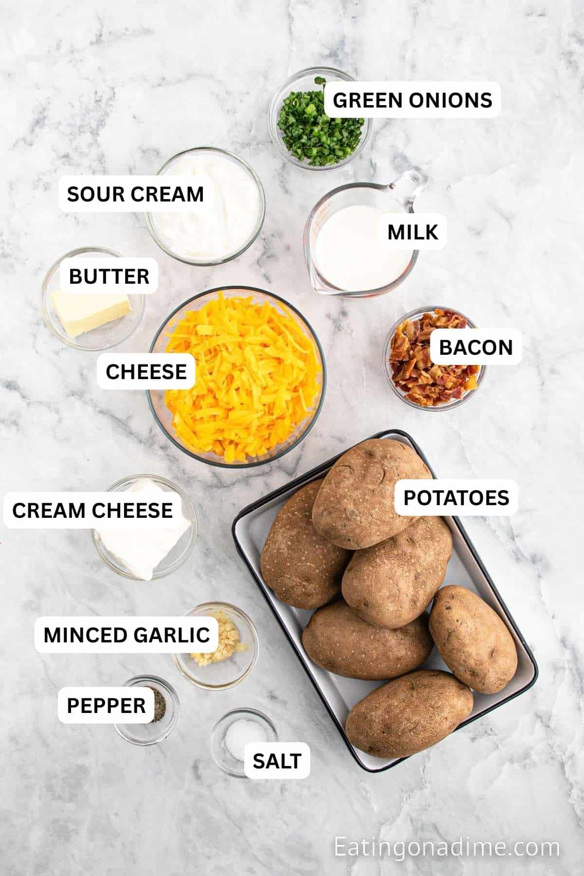 Ingredients for recipe: Russet Potatoes, minced garlic, cream cheese, sour cream, butter, milk, salt, pepper, bacon, cheese and green onions.