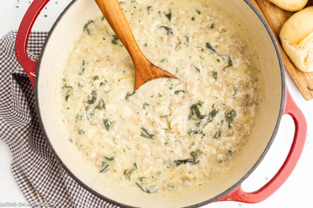 Zuppa Toscana in Dutch Oven with wooden spoon