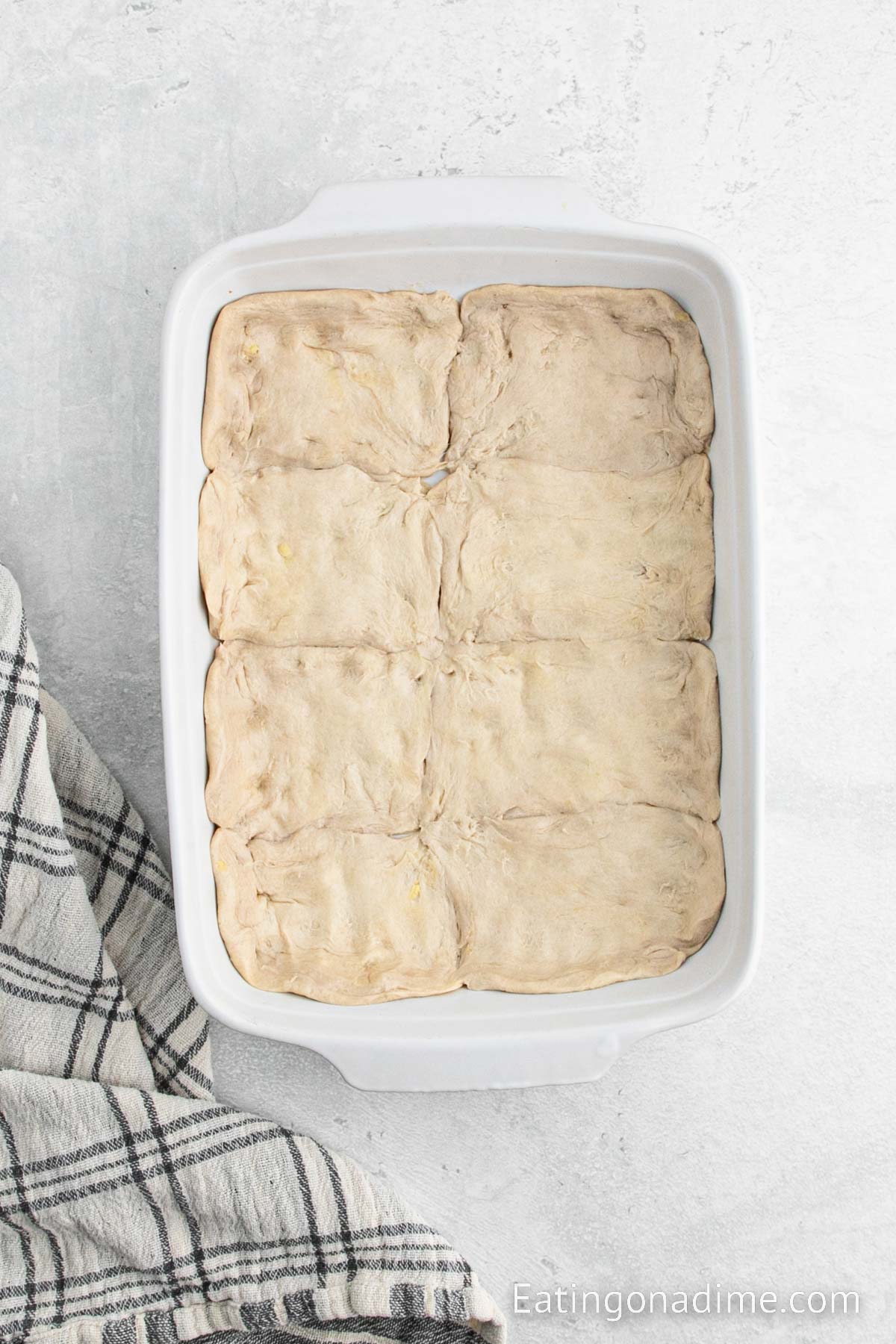 Spreading the biscuits into the baking dish