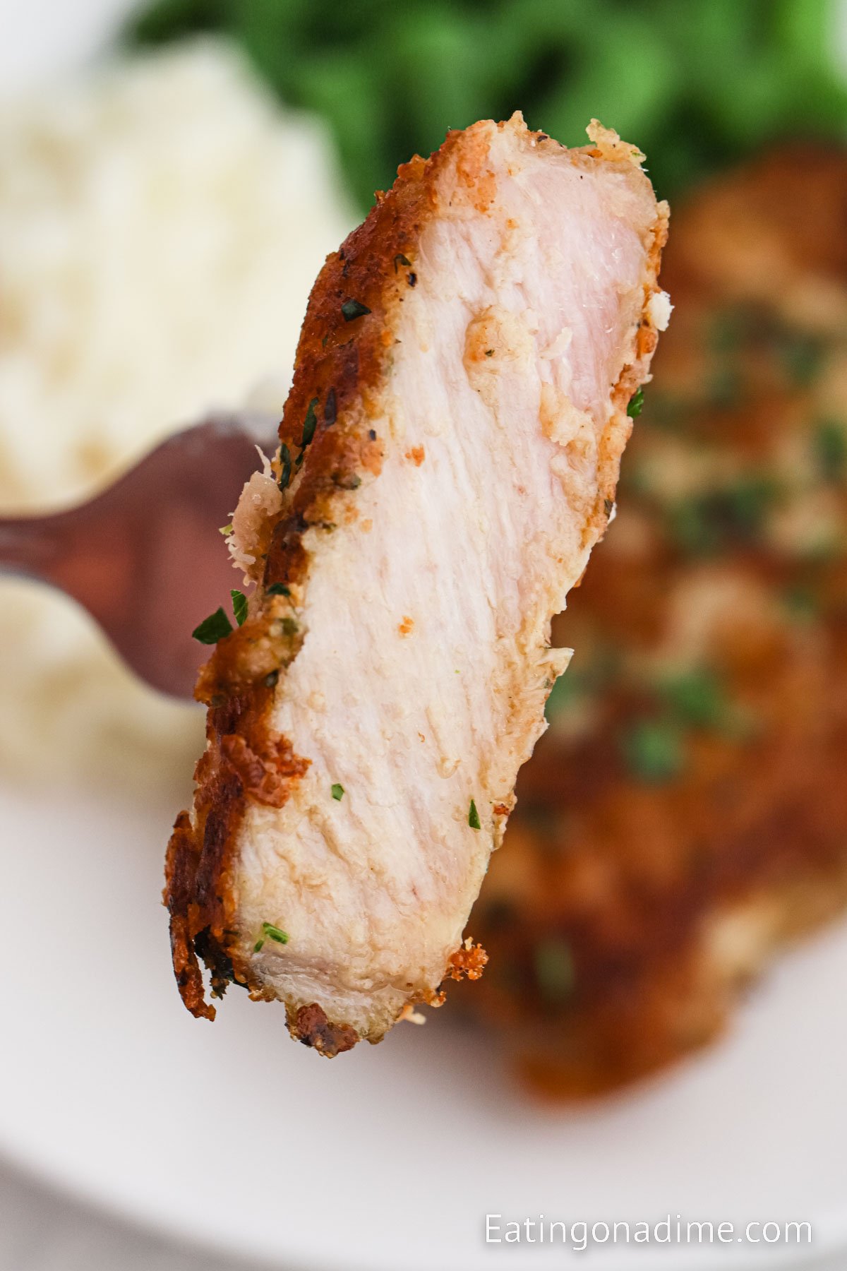 Parmesan Crusted Pork Chops on a fork