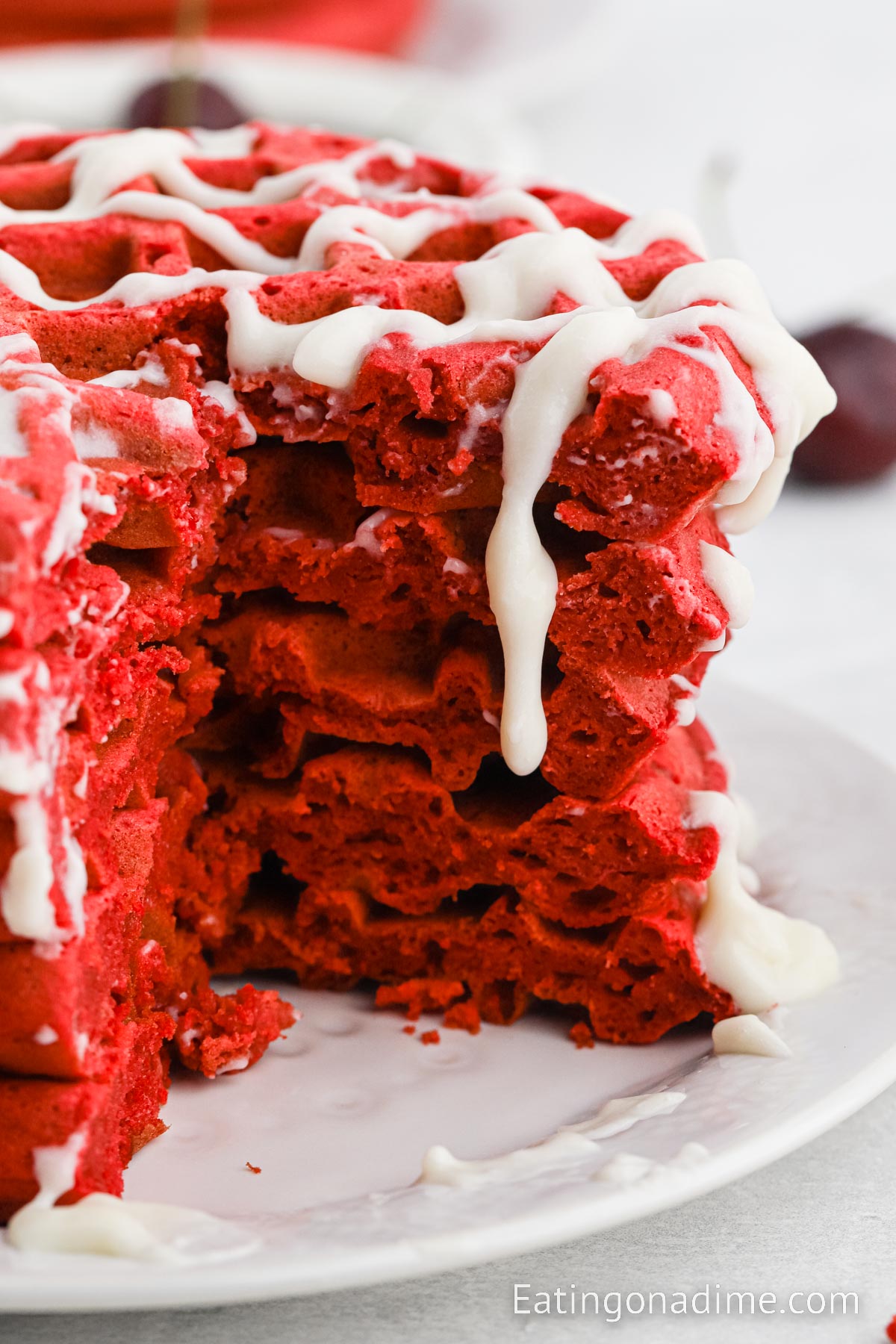 Red Velvet Waffles Stacked and topped with cream cheese glaze