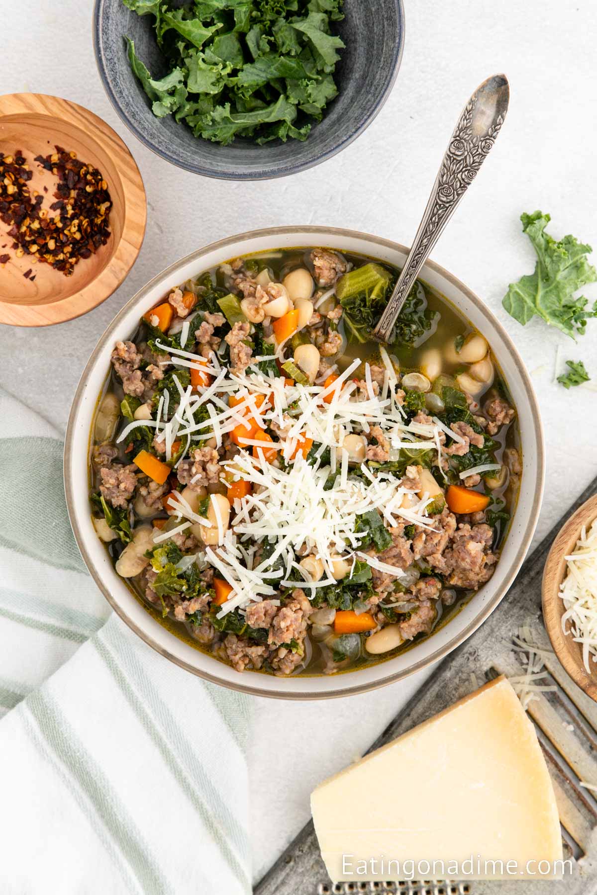 Sausage Kale White Bean Soup in a bowl with a spoon