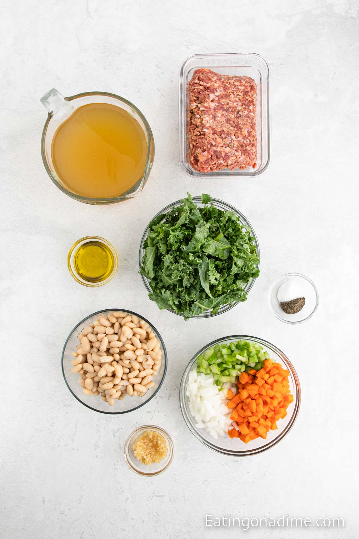 Olive oil, sausage, onion, celery, carrots, garlic, salt and pepper, beans, chicken broth, kale, parmesan cheese