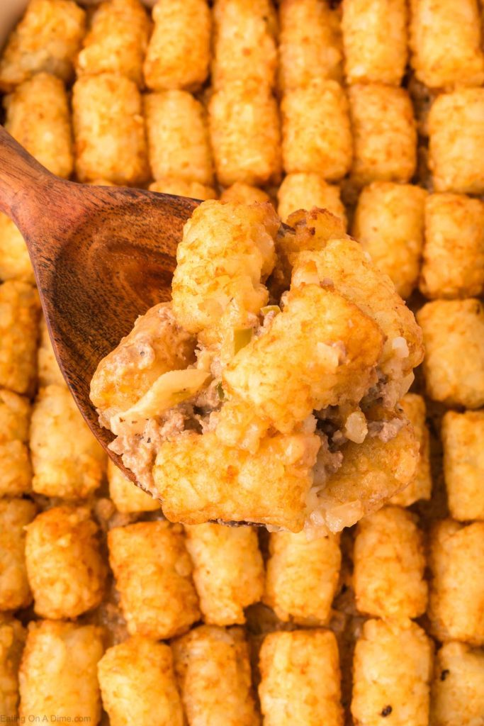 Big Mac Tater Tot Casserole with a serving on a wooden spoon