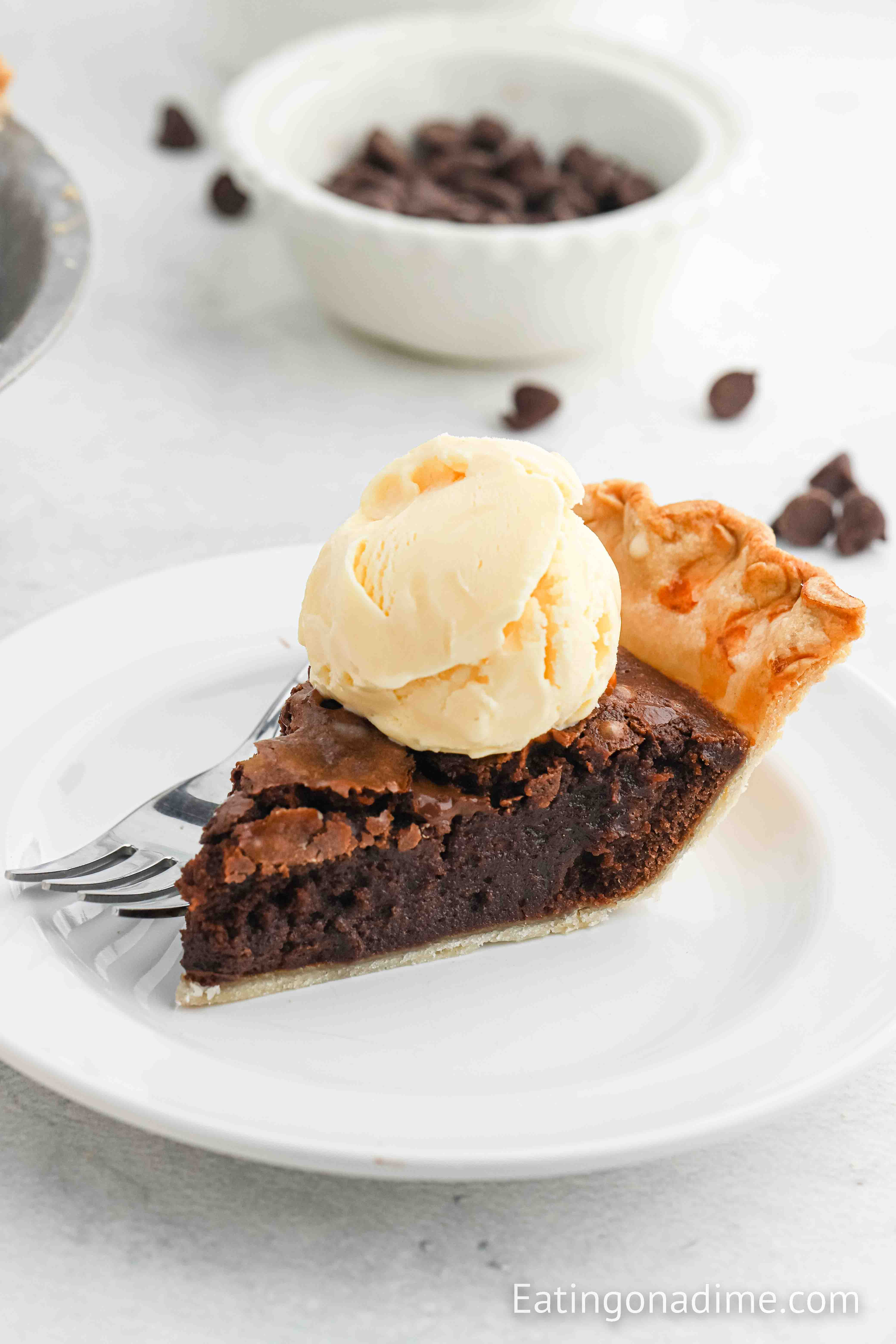 Close up image of Brownie Pie on a plate with a scoop of ice cream