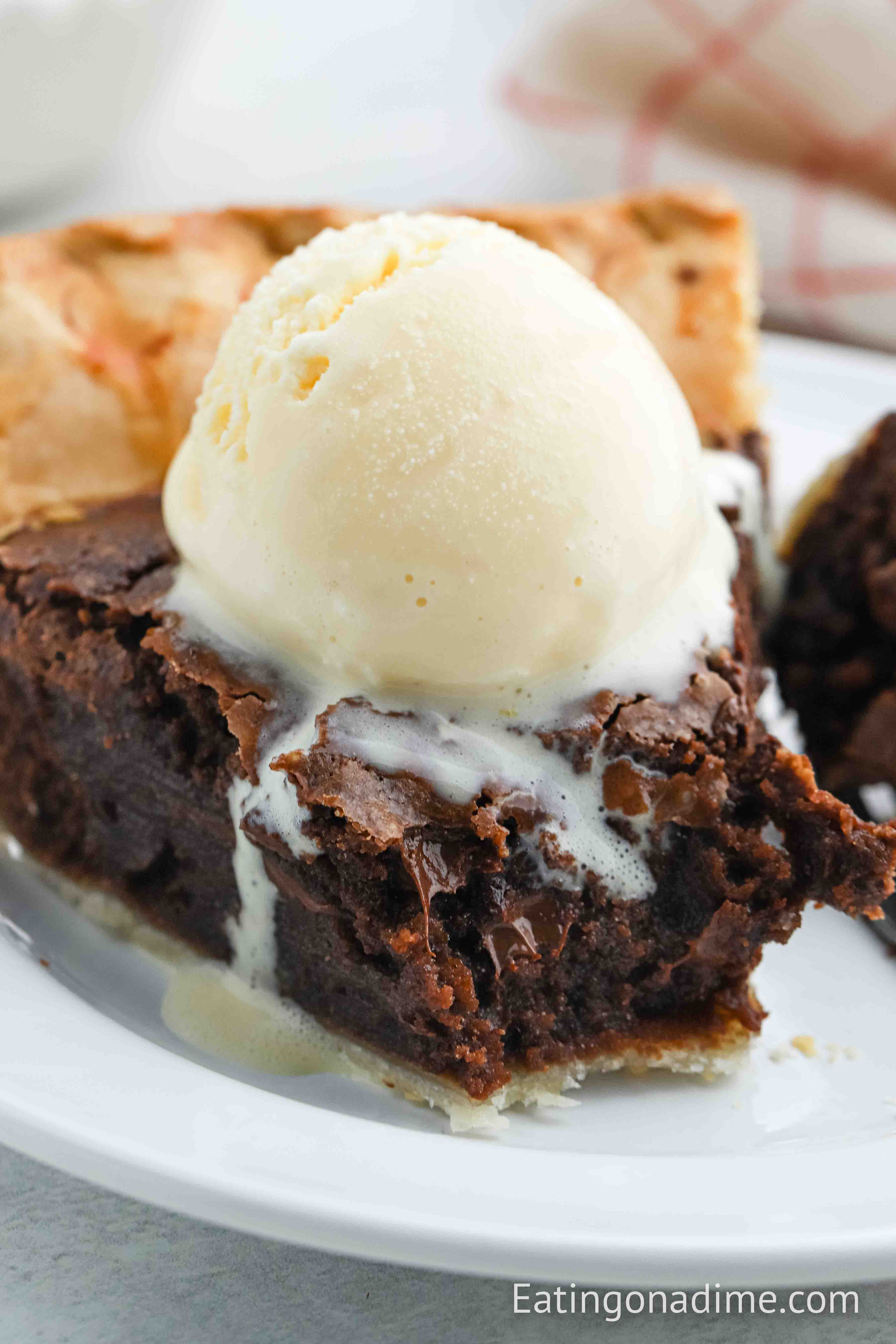 Close up image of Brownie Pie with a scoop of ice cream