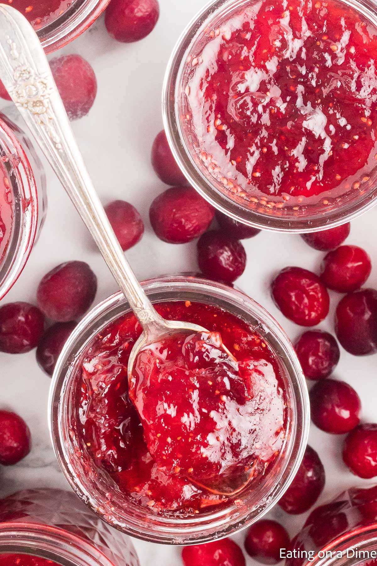 Christmas jam in jars with a serving on the spoon