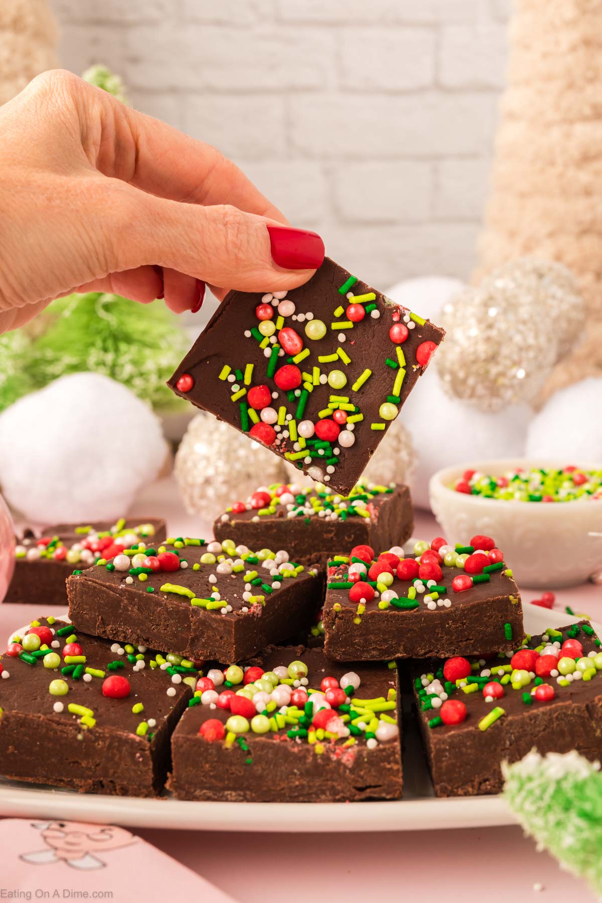 Christmas Fudge cut into squares on a platter. 