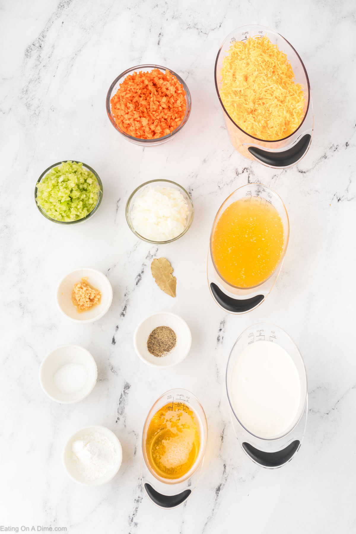 Ingredients needed for beer cheese soup - carrots, onion, celery, garlic, salt, pepper, bay leaf, chicken broth, beer, heavy cream, corn starch, cheese
