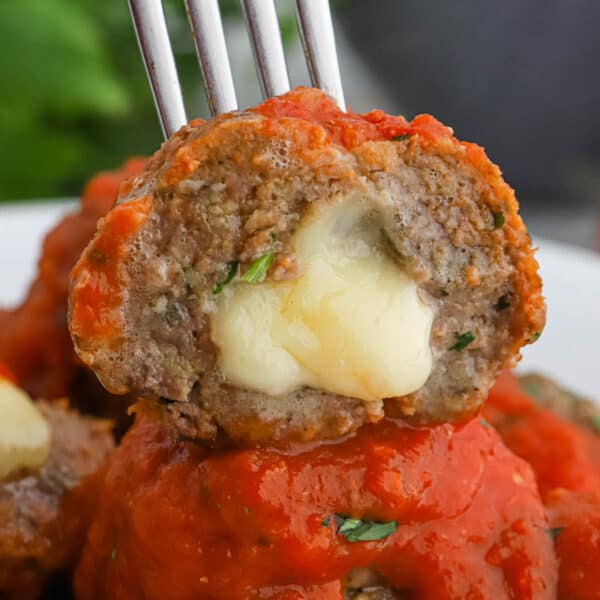 A close up of mozzarella stuffed meatballs.