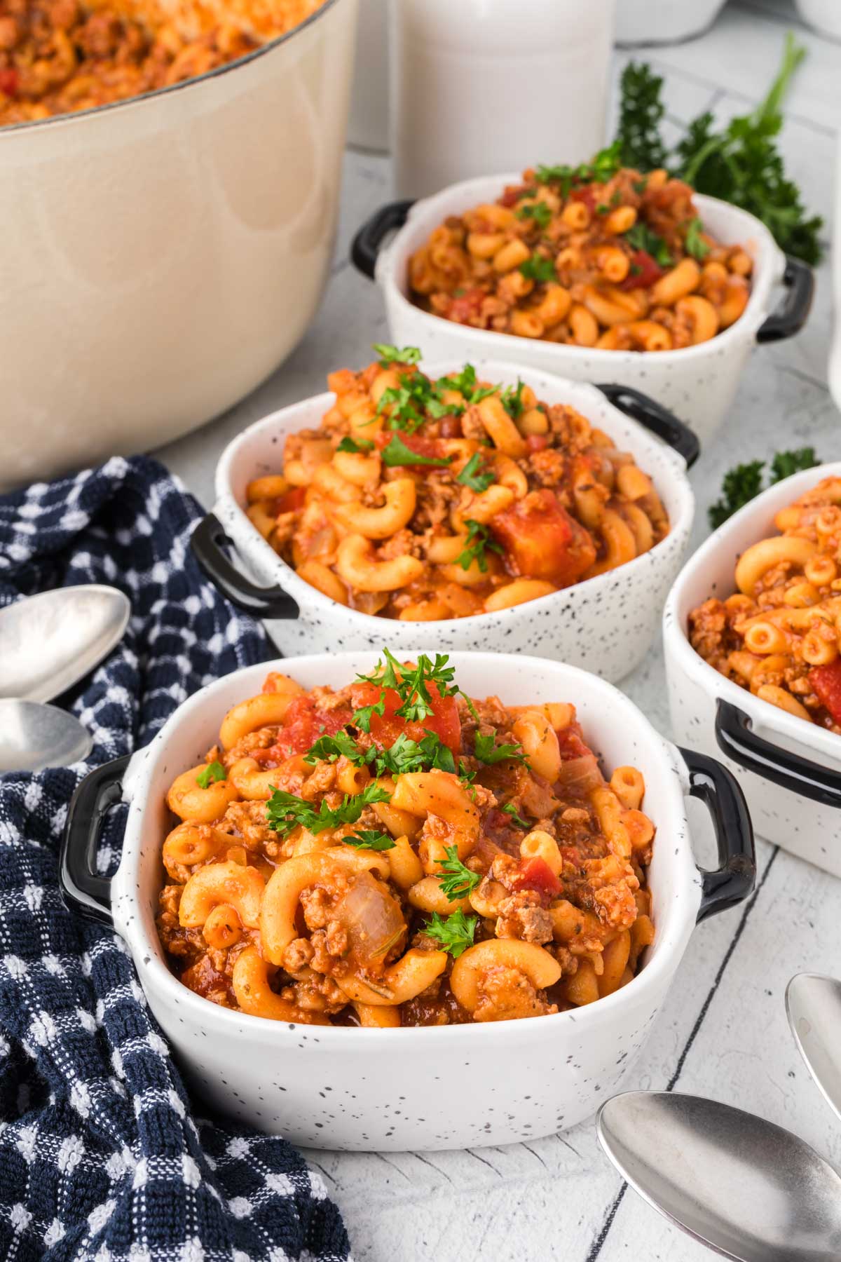 Goulash in white speckled bowls. 