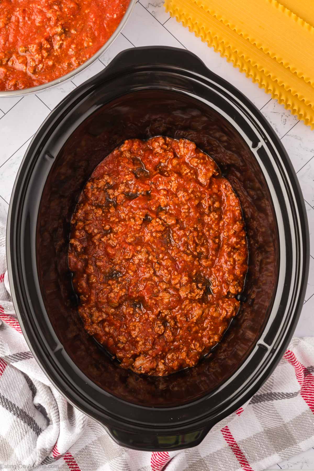 Layering the sauce in the slow cooker