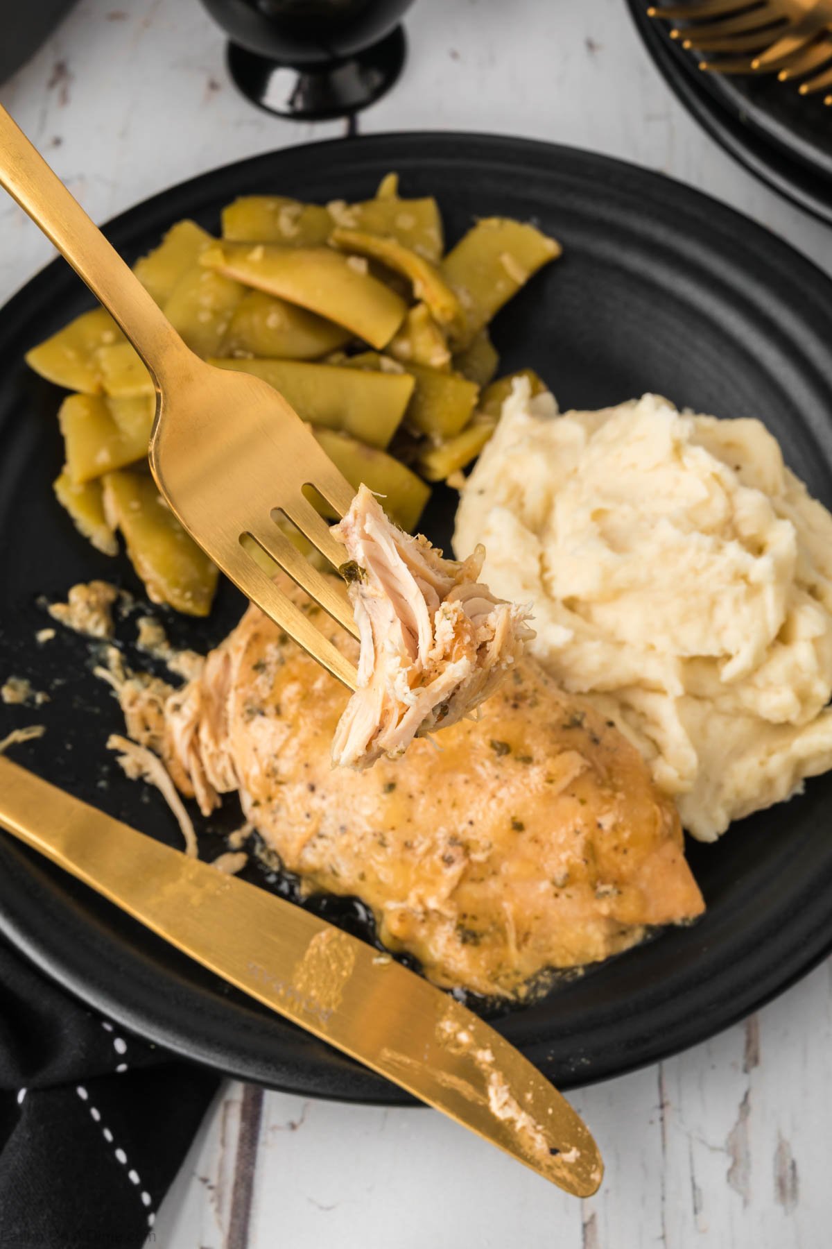 Ranch chicken on a plate with mashed potatoes and green beans