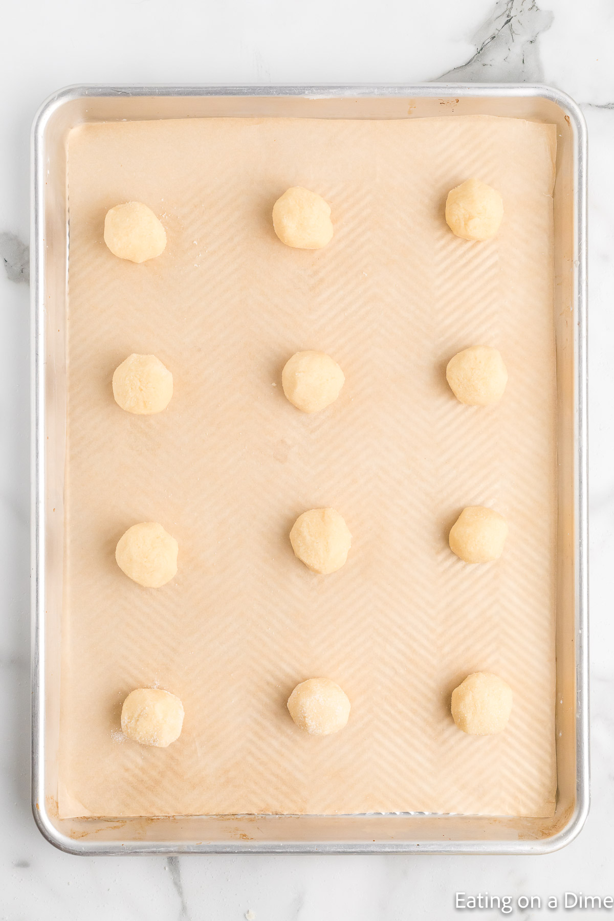 Sugar Cookie Dough balls on a baking sheet