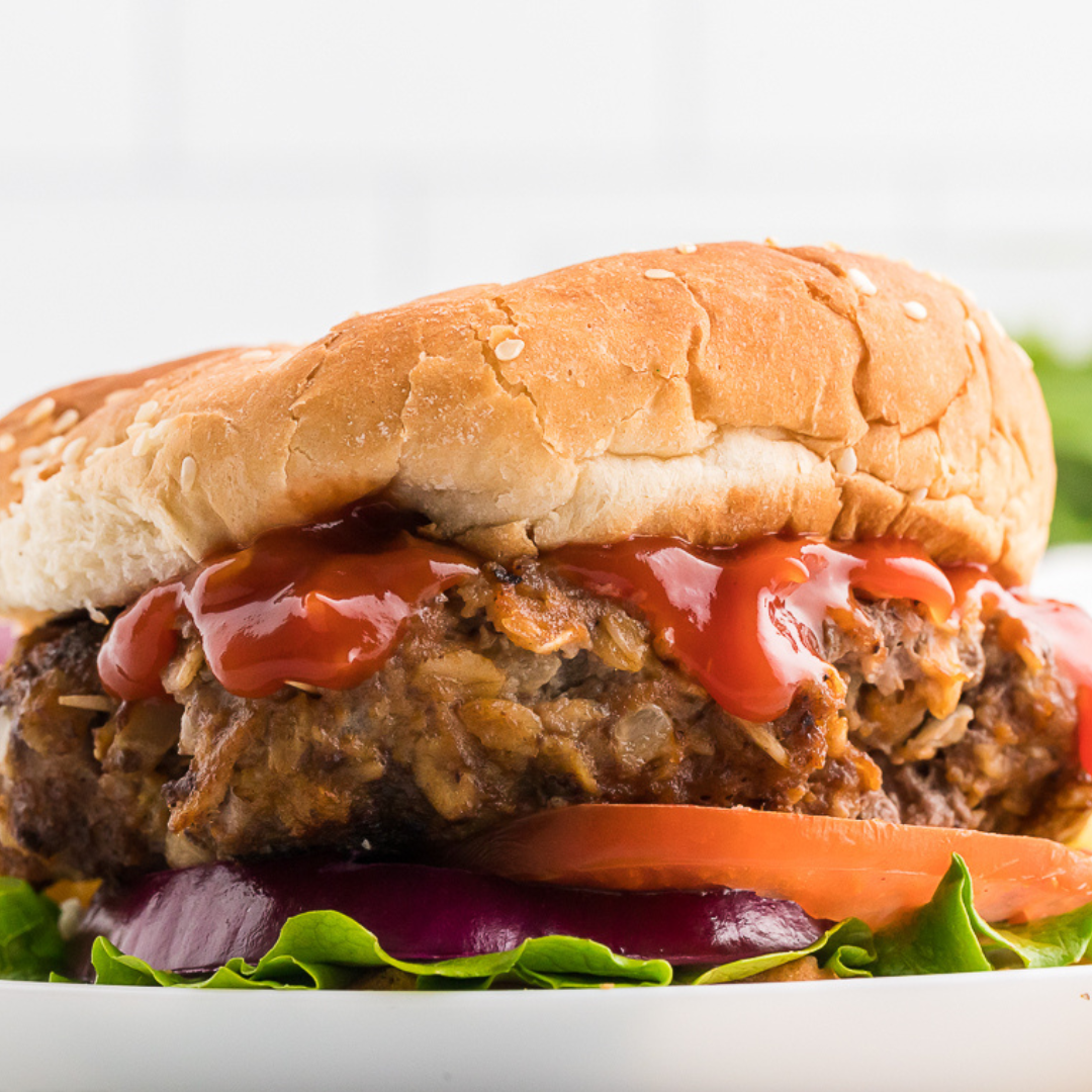 Meatloaf burgers layered with tomato, red onions, and lettuce
