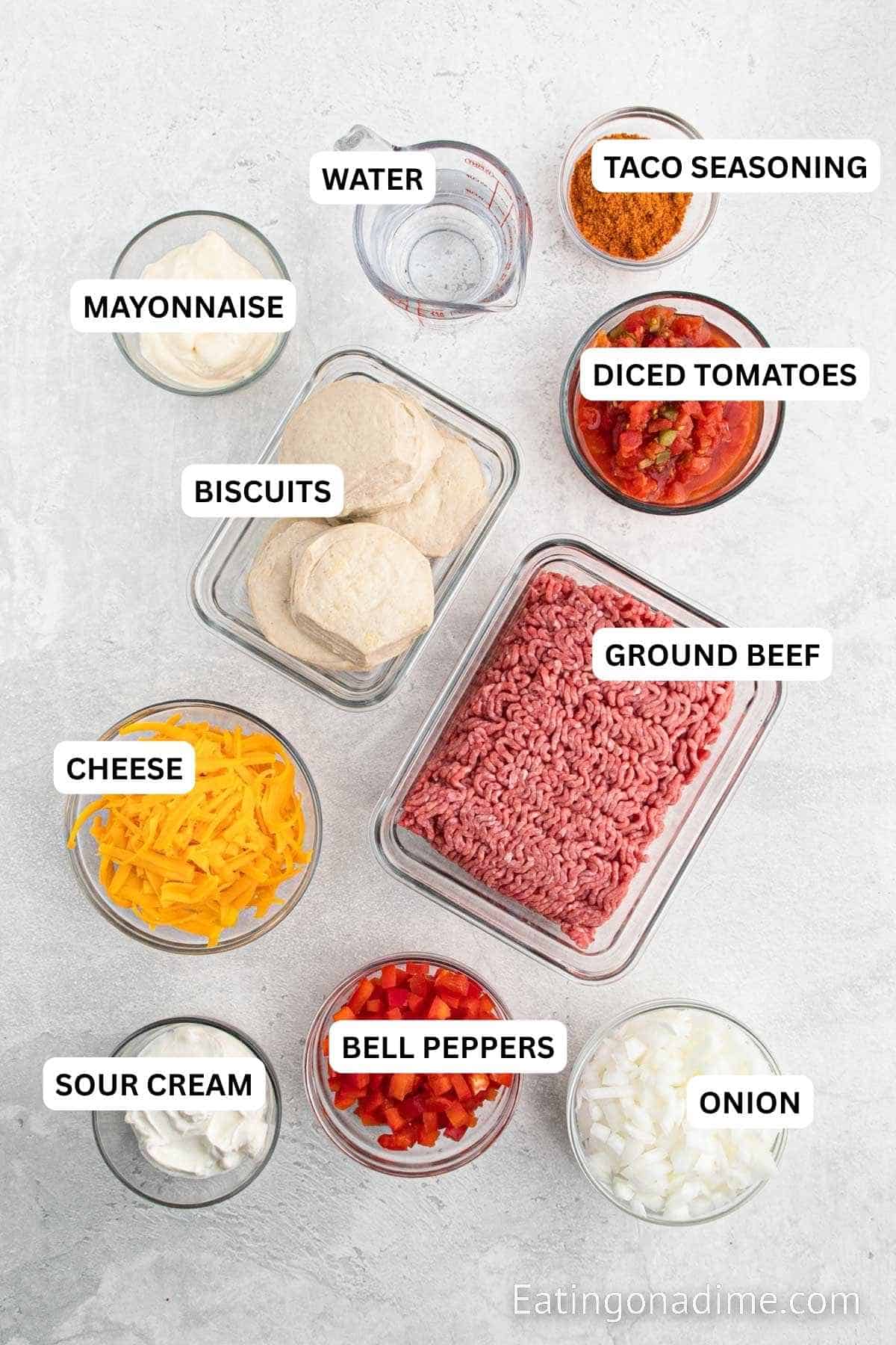 Ingredients needed recipe: Biscuits, beef, taco seasoning, water, onion, bell pepper, diced tomatoes, sour cream, mayonnaise and cheese.