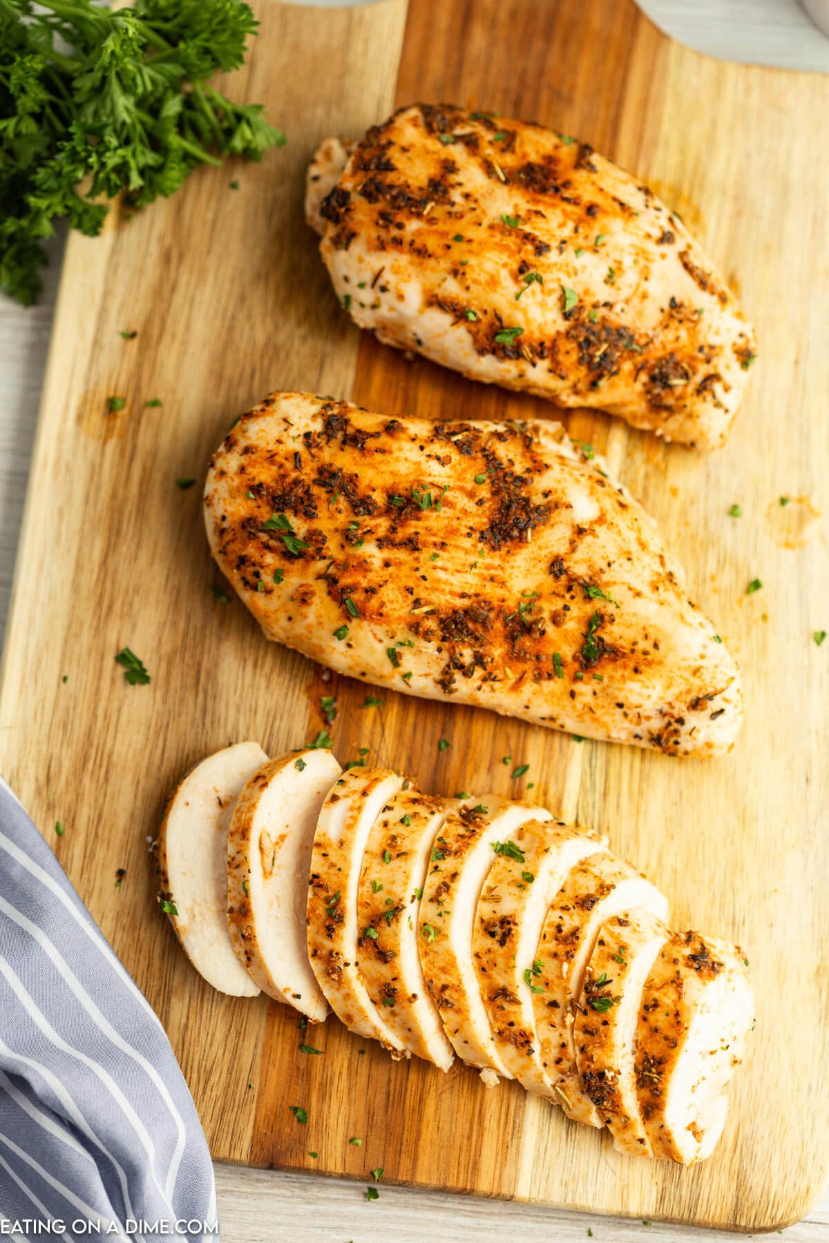 Slice cooked chicken breast on a cutting board