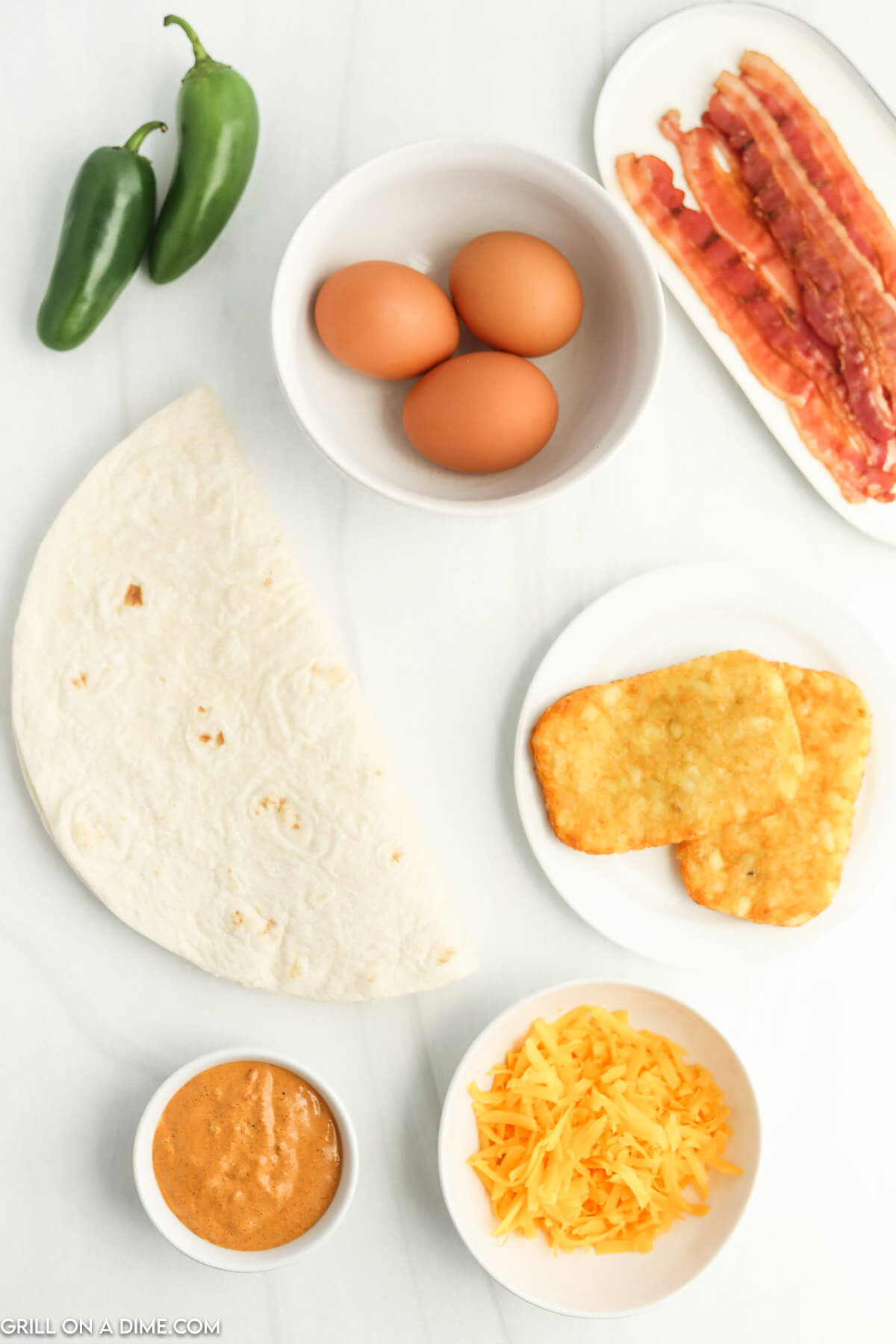 Ingredients needed - eggs, cheese, bacon, frozen hash browns, tortillas, jalapeno sauce, oil