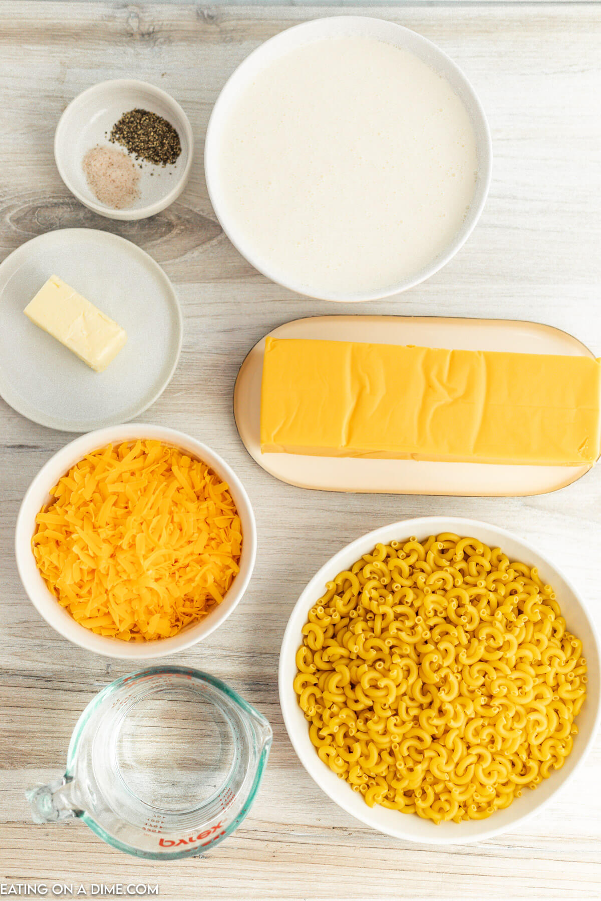 Velveeta cheese, macaroni pasta, heavy cream, water, salt, pepper, butter, cheddar cheese