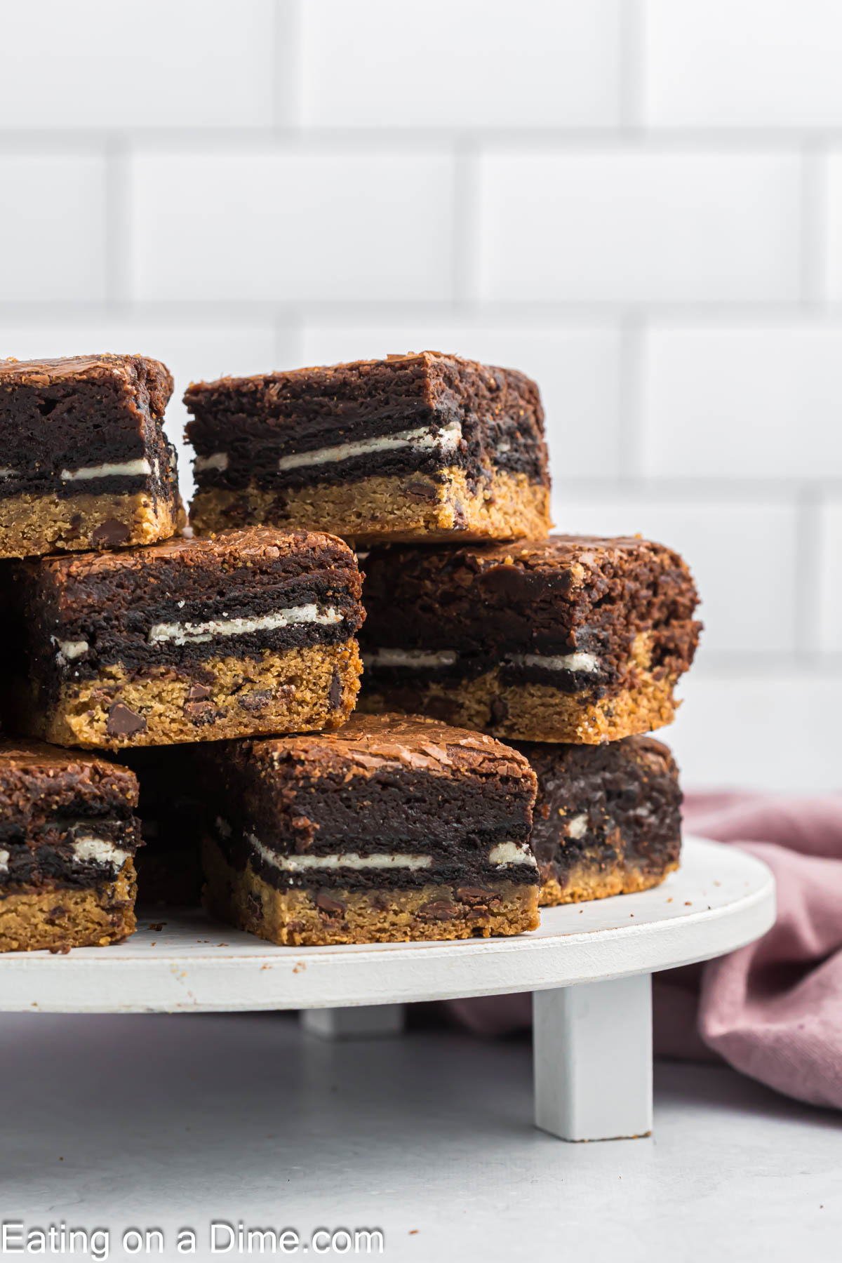 Slutty Brownies cut into squares and stacked on a platter