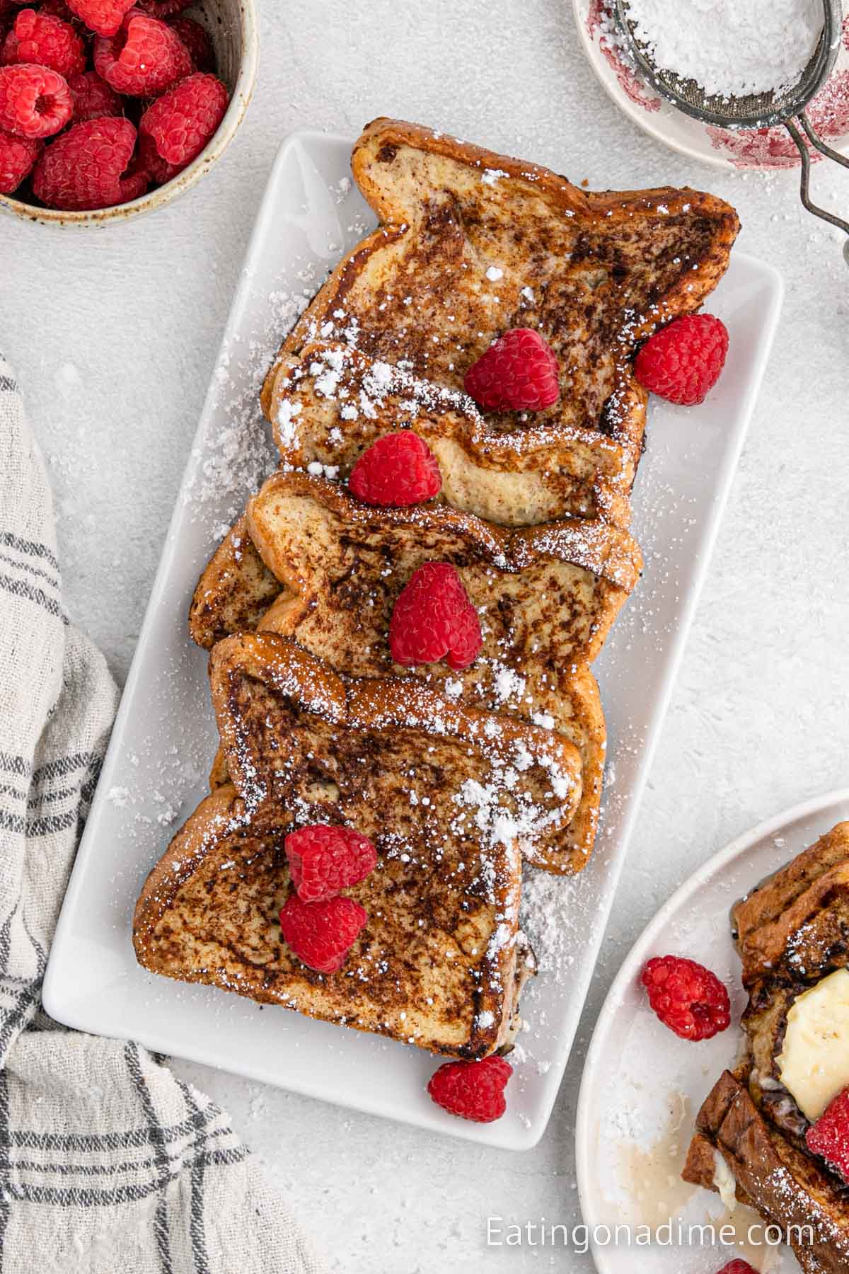 Cinnamon French Toast on a platter topped with berries